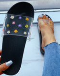 Sandales plates transparentes à motif floral