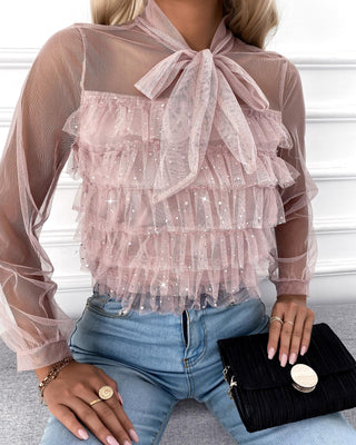 Blouse cloutée en maille transparente à encolure nouée