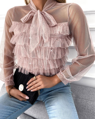 Blouse cloutée en maille transparente à encolure nouée
